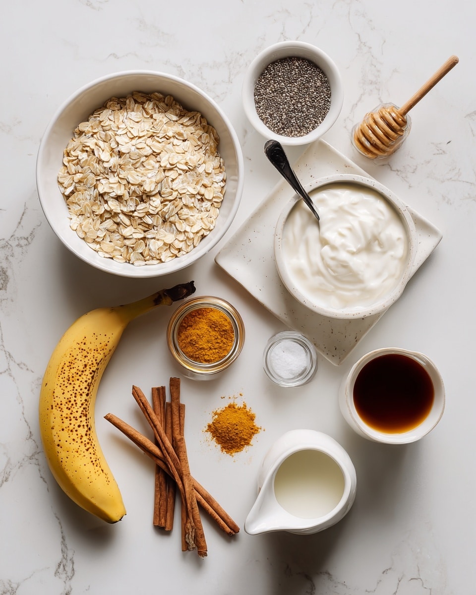 A flat lay image shows various ingredients arranged on a white marbled surface. There is a large white bowl filled with light beige rolled oats near the center-left. Above it, a small white bowl contains tiny black chia seeds. To the right, a small white bowl holds thick white yogurt with a black spoon inside. Nearby, a white bowl with a honey dipper rests in golden honey. A small spice jar with orange cinnamon powder and a spoonful of the same powder lie between the oats and yogurt. At the bottom left, a white tray holds one whole ripe banana with brown spots and one peeled banana sliced in half lengthwise, showing creamy light yellow flesh. A clear glass jar with cinnamon sticks is to the side. On the right, a small light beige cup has a dark brown liquid, and in front of it is a white ceramic pitcher of milk. A white salt shaker stands near the honey bowl. The photo taken with an iphone --ar 4:5 --v 7