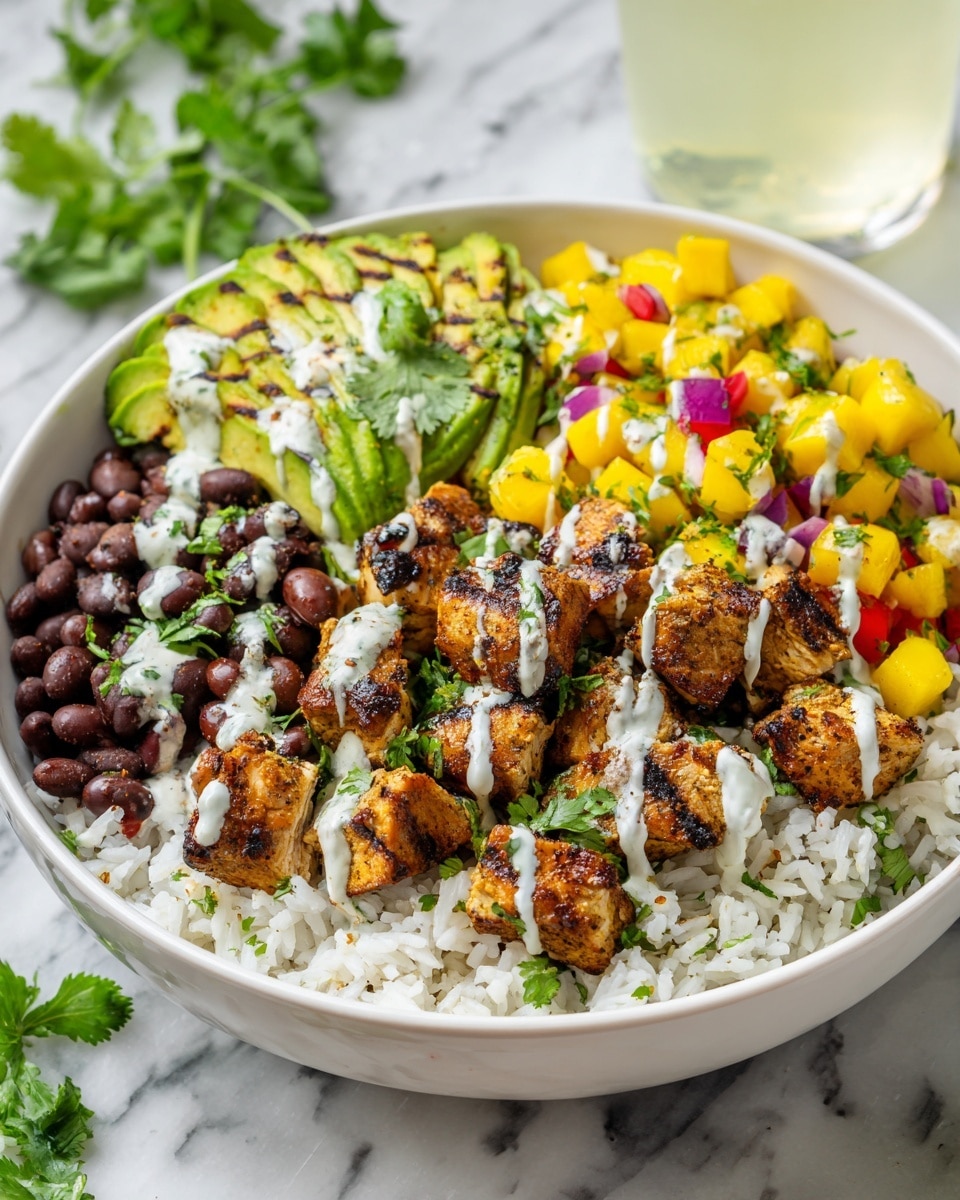 In a white bowl on a white marbled texture, there is a layer of white rice at the bottom. On top of the rice, there are pieces of golden-brown seasoned chicken with a creamy light sauce drizzled over them. To the side, there are dark red beans with some green cilantro leaves scattered around. Next to the beans, there are slices of green avocado topped with the same creamy sauce and more cilantro. Above the chicken, there is a colorful mix of yellow mango cubes, red diced tomatoes, and bits of red onion, all garnished with fresh green cilantro leaves. A glass with a light beige drink is visible on the top right corner. Photo taken with an iphone --ar 4:5 --v 7