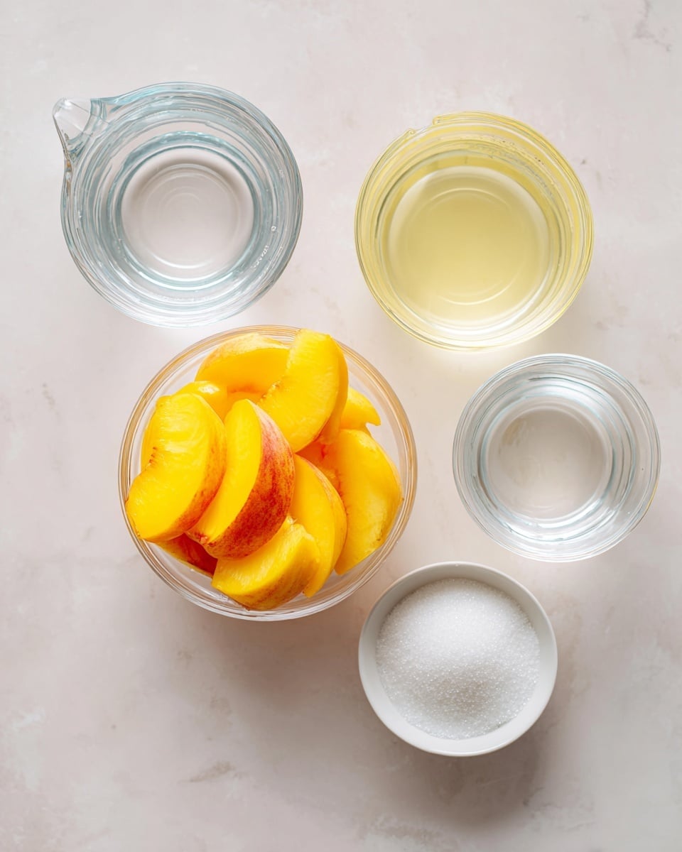 The image shows four clear glass containers on a white marbled surface. In the center, there is a small glass bowl filled with bright yellow and orange peach slices, showing soft and juicy texture. Around it are three glass measuring cups; one contains clear water at the top left, the second in the bottom left has a pale yellow liquid, likely lemon juice, and the third on the top right holds clear water as well. To the bottom right, there is a small white bowl filled with white granulated sugar. The overall scene is clean and bright, with soft natural light. Photo taken with an iphone --ar 4:5 --v 7