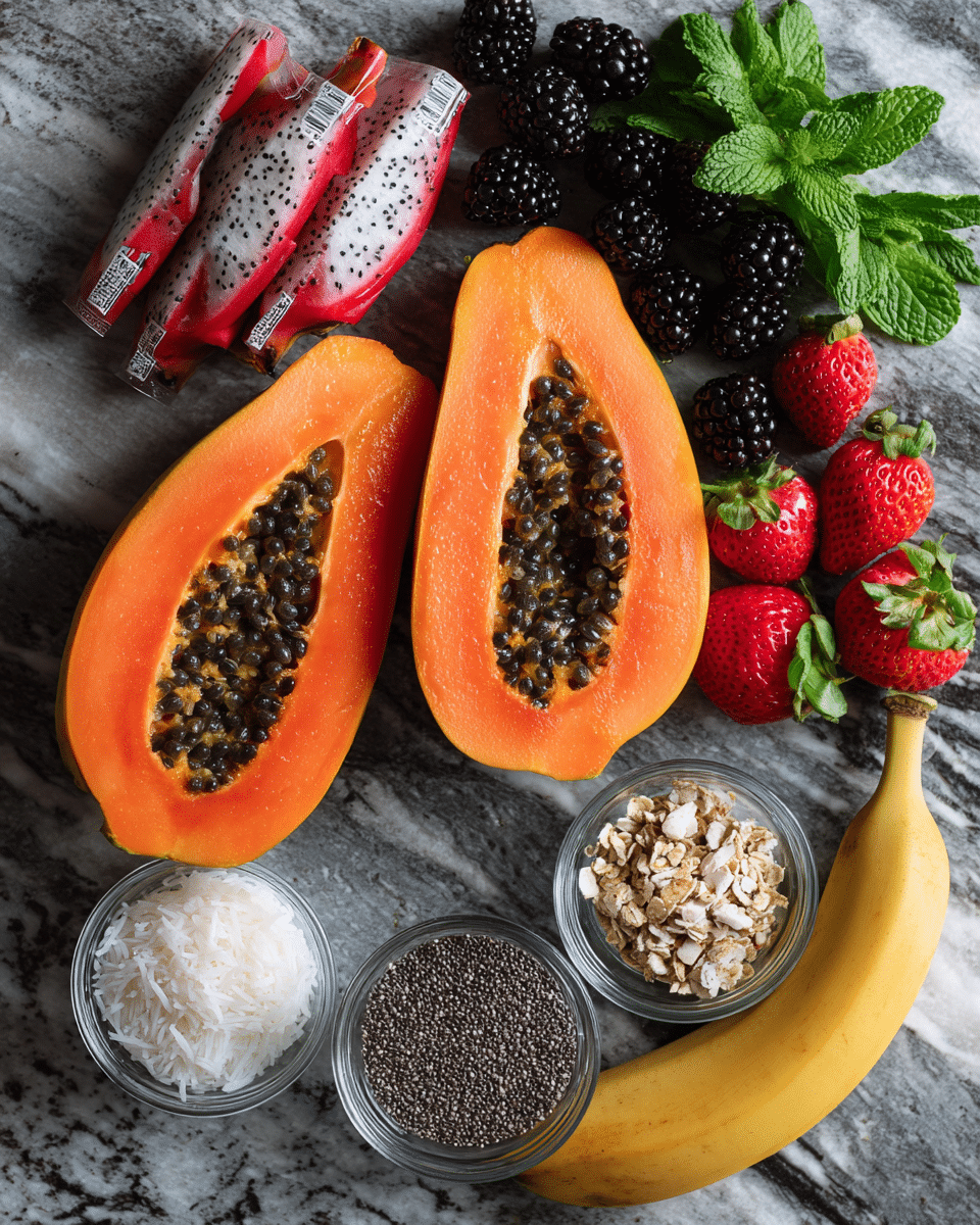 The image shows two halves of a bright orange papaya with seeds inside, placed on a dark gray surface. Next to the papaya, there is a pile of blackberries, some strawberries with green tops, and two yellow bananas. In front of the fruits, there are three small clear glass bowls: one filled with black chia seeds, one with white shredded coconut, and one with brown crunchy granola. There are also two red and white dragon fruit packages near the top left corner. Fresh green mint leaves are scattered near the fruits. The setting is on a white marbled texture surface. photo taken with an iphone --ar 4:5 --v 7