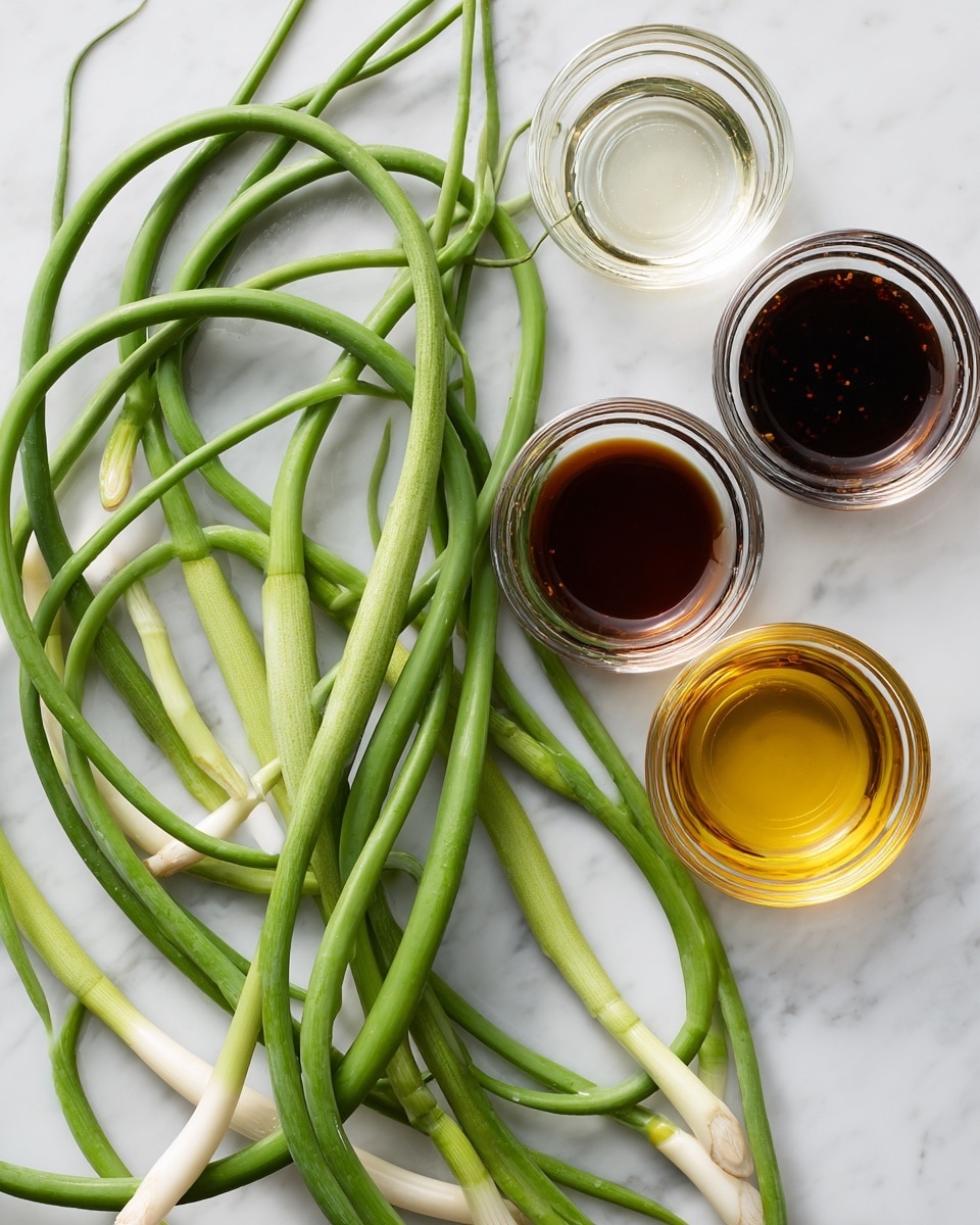 A group of long, coiled green garlic scapes with smooth, shiny texture and pale white sections near the base lies on a white marbled surface. To the right, three small clear glass bowls are arranged in a triangle, each holding a different liquid: the top one is empty or clear, the middle one has a dark brown sauce, and the bottom one contains a golden-yellow oil. The arrangement is simple and clean, showing fresh ingredients on the white marbled background. photo taken with an iphone --ar 4:5 --v 7