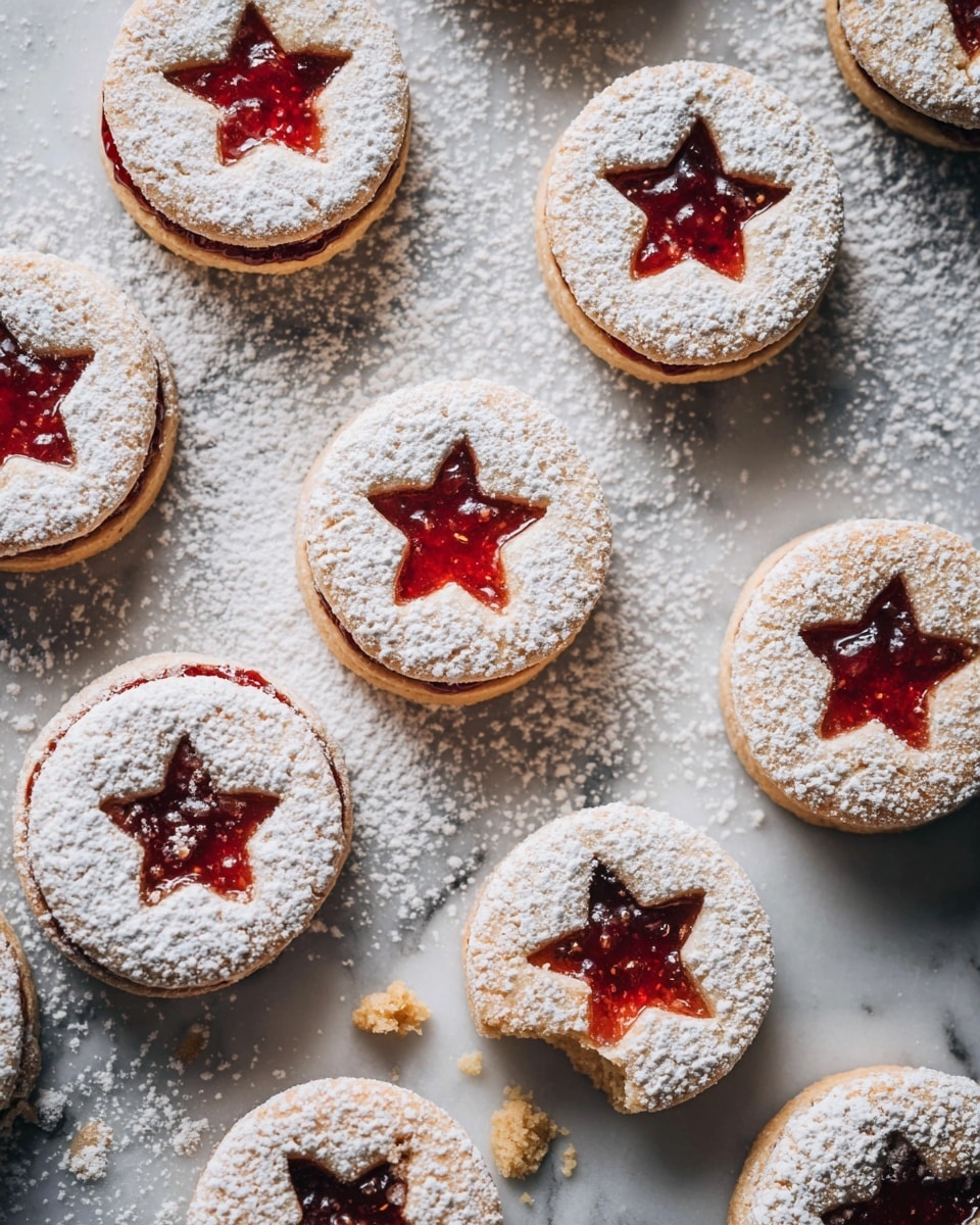 A white plate filled with round sandwich cookies stacked unevenly, each cookie has two layers of light brown cookie dough with scalloped edges, a visible center cut-out in star or maple leaf shape showing a layer of red or orange jam inside, and a dusting of white powdered sugar on top; at the bottom right, a woman's hand is holding one cookie with a bite taken out, all on a white marbled surface photo taken with an iphone --ar 4:5 --v 7