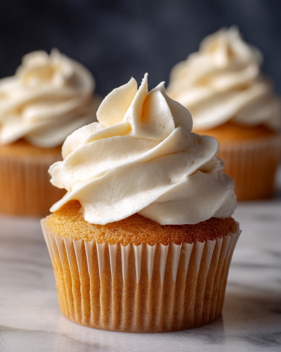 This image shows thick, white cream or frosting clinging to a metal whisk. The cream looks smooth and slightly fluffy, with soft peaks formed by the whisk. The strands of cream stretch from the center to the edges of the whisk, showing a rich and textured surface. The cream has a glossy finish and looks fresh. The background is dark and blurry, making the creamy texture stand out clearly. photo taken with an iphone --ar 4:5 --v 7