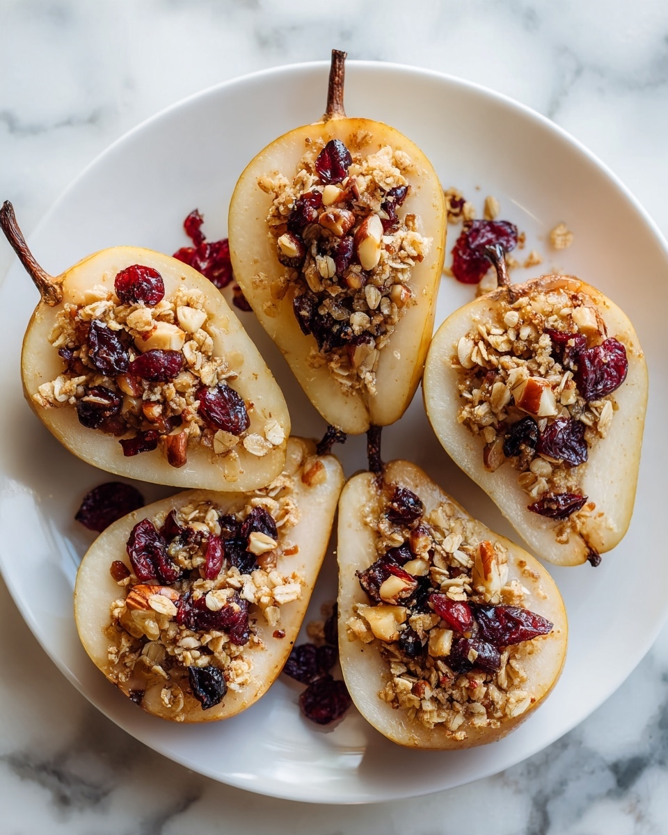 Five pear halves are placed open side up on a white plate, arranged closely in a loose circle filling the center. Each pear half has a hollowed middle filled with a thick layer of a granola mix that includes oats, raisins, and nuts, showing a textured, chunky appearance with shades of brown and dark purple. The pear flesh is light cream with a soft texture, and the pear skins are golden with a smooth, slightly shiny surface. A light dusting of cinnamon covers the exposed pear flesh and granola topping, adding a soft brown tint. The white plate rests on a white marbled surface. photo taken with an iphone --ar 4:5 --v 7