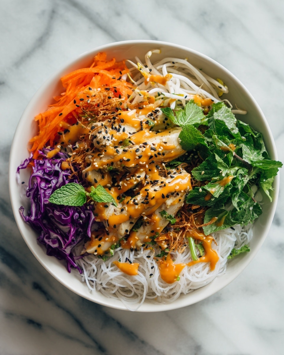 A white bowl filled with a colorful layered dish starting with a base of thin white rice noodles, topped with shredded purple cabbage and thin orange carrot strips. Fresh green cilantro leaves and mint sprigs are scattered around, with bean sprouts adding a light crunch near the top. Several slices of white cooked chicken with a smooth texture rest on one side, drizzled with a reddish-orange sauce and sprinkled with black sesame seeds. Crispy golden brown fried shallots are spread across the dish, adding texture and a rich look. The bowl sits on a white marbled surface. photo taken with an iphone --ar 4:5 --v 7