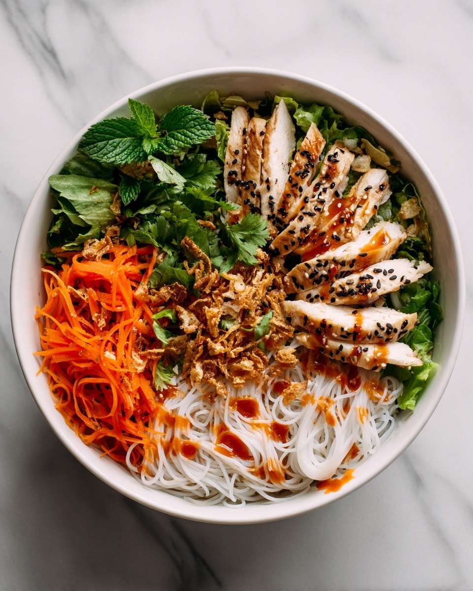 The dish shows a white bowl filled with many fresh layers starting at the base with thin white rice noodles, followed by shredded light purple cabbage and bright orange carrot strips on the left side. On top, there is a layer of whole green mint and cilantro leaves mixed with white bean sprouts. The central focus is several slices of white cooked chicken placed slightly to the left, sprinkled with black sesame seeds. Scattered fried crispy bits add a darker brown texture over the herbs. The whole dish is drizzled with a shiny reddish-brown sauce, all presented on a white marbled surface. Photo taken with an iphone --ar 4:5 --v 7