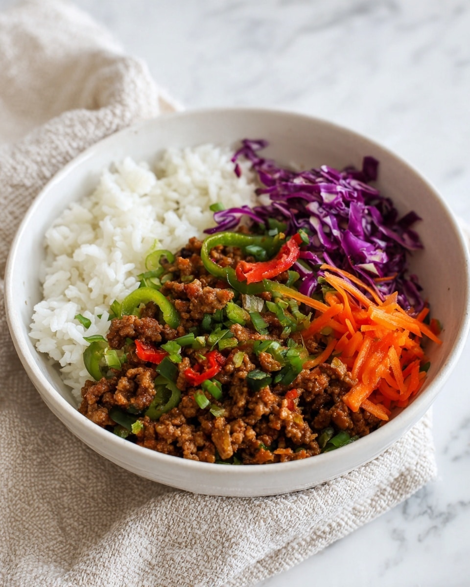A white bowl sits on a white marbled surface with a light beige textured cloth nearby, filled with three visible layers: the bottom layer of white cooked rice with a soft and fluffy texture, the middle layer of minced meat cooked with sliced green bell peppers showing brown and green colors, and the top layer garnished with thin orange carrot strips and small pieces of purple cabbage, adding a fresh and colorful touch. photo taken with an iphone --ar 4:5 --v 7