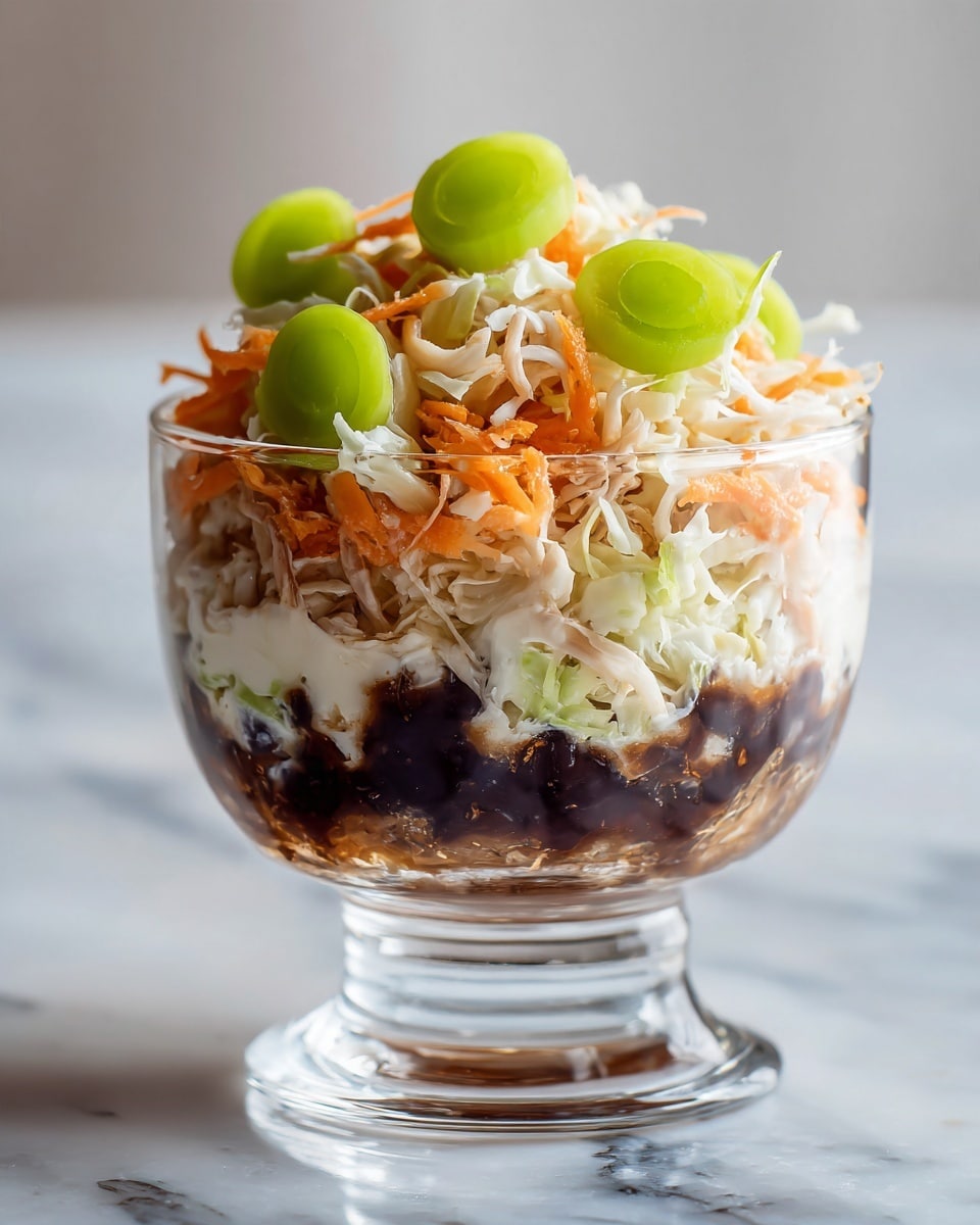 A clear glass bowl filled with a layered salad sits on a white marbled surface. The bottom layer is dark brown with a shiny, sticky texture. On top, there is a mix of shredded white cabbage and thin orange carrot strips, giving a fresh and crisp look. Scattered on the top layer are thick, bright green slices of celery, adding a pop of color and a crunchy texture to the salad. The bowl has a rounded base and a wide rim, with the salad heaped high above the edges. Photo taken with an iphone --ar 4:5 --v 7