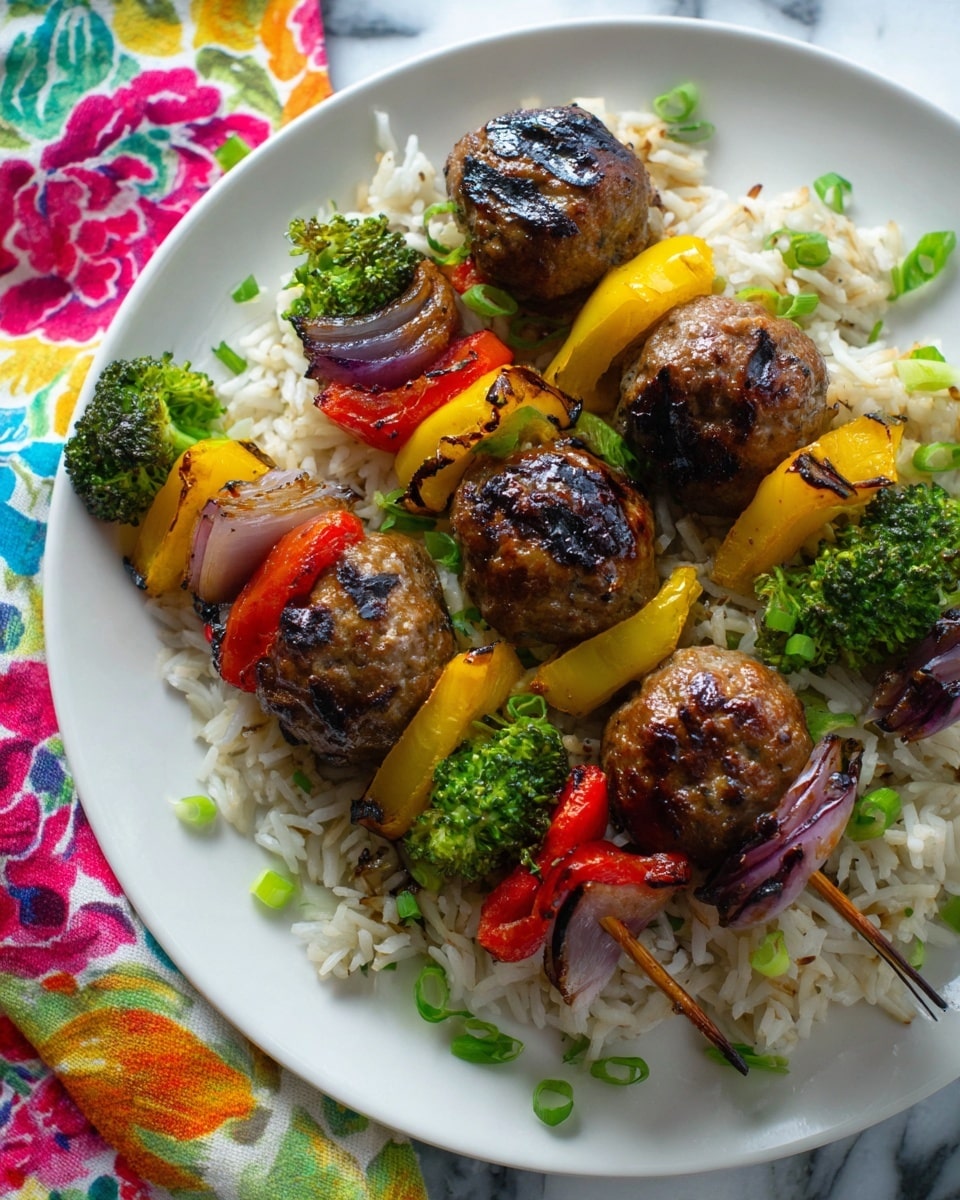 Two skewers rest on a bed of white rice on a white plate, placed on a white marbled surface. Each skewer has four grilled meatballs that are brown with charred spots, interspersed with green broccolis, red bell peppers, and chunks of light purple onion, all showing slight grill marks. The dish is lightly garnished with small round green onion slices scattered over the rice and skewers. The background has a colorful floral cloth with orange, pink, yellow, and black petals. Photo taken with an iphone --ar 4:5 --v 7