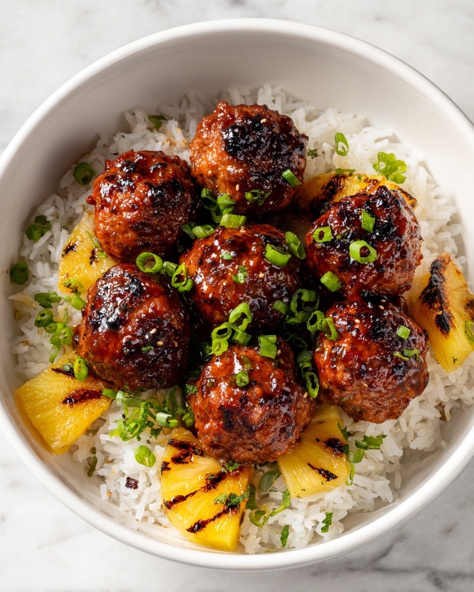 Seven glossy brown meatballs covered in shiny dark sauce sit on top of a bed of white rice with small pieces of grilled yellow pineapple mixed in. The meatballs are sprinkled with bright green chopped scallions. The dish is served in a white bowl and placed on a white marbled surface. photo taken with an iphone --ar 4:5 --v 7